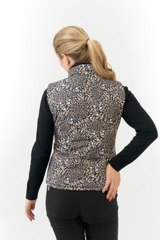 The Pure Golf Eve reversible ladies gilet for golf is insulated, winter-weight, patterned and reversible. It has been Insulated for warmth without being bulky. It has a unique animal print in wild truffle,  on one side and black on the other for versatility of wear. It has pockets on both sides and two-way zippers. The flattering quilting style and fit enhances your silhouette. The colors in this  this piece are Cappuccino,  Champagne and black.  