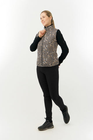 The Pure Golf Eve reversible ladies gilet for golf is insulated, winter-weight, patterned and reversible. It has been Insulated for warmth without being bulky. It has a unique animal print in wild truffle,  on one side and black on the other for versatility of wear. It has pockets on both sides and two-way zippers. The flattering quilting style and fit enhances your silhouette. The colors in this  this piece are Cappuccino,  Champagne and black.  