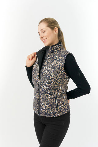 The Pure Golf Eve reversible ladies gilet for golf is insulated, winter-weight, patterned and reversible. It has been Insulated for warmth without being bulky. It has a unique animal print in wild truffle,  on one side and black on the other for versatility of wear. It has pockets on both sides and two-way zippers. The flattering quilting style and fit enhances your silhouette. The colors in this  this piece are Cappuccino,  Champagne and black.  