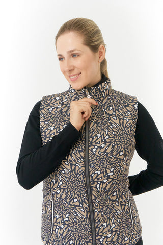 The Pure Golf Eve reversible ladies gilet for golf is insulated, winter-weight, patterned and reversible. It has been Insulated for warmth without being bulky. It has a unique animal print in wild truffle,  on one side and black on the other for versatility of wear. It has pockets on both sides and two-way zippers. The flattering quilting style and fit enhances your silhouette. The colors in this  this piece are Cappuccino,  Champagne and black.  