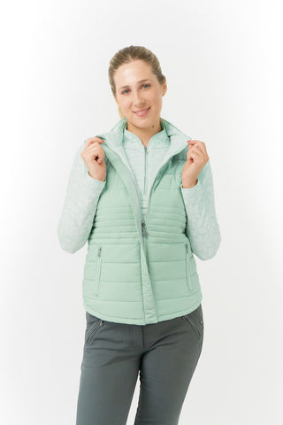 Frosted Sage Pure Golf Eve reversible ladies gilet for golf is insulated, winter-weight, patterned and reversible. It has been Insulated for warmth without being bulky. It has a unique frosted field, floral print  on one side and plain frosted sage on the other for versatility of wear. It has pockets on both sides and two-way zippers. The flattering quilting style and fit enhances your silhouette. 