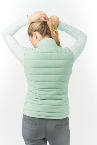 Frosted Sage Pure Golf Eve reversible ladies gilet for golf is insulated, winter-weight, patterned and reversible. It has been Insulated for warmth without being bulky. It has a unique frosted field, floral print  on one side and plain frosted sage on the other for versatility of wear. It has pockets on both sides and two-way zippers. The flattering quilting style and fit enhances your silhouette. 