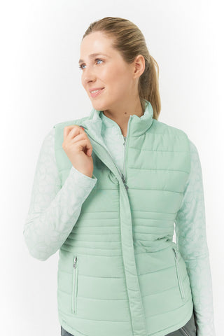 Frosted Sage Pure Golf Eve reversible ladies gilet for golf is insulated, winter-weight, patterned and reversible. It has been Insulated for warmth without being bulky. It has a unique frosted field, floral print  on one side and plain frosted sage on the other for versatility of wear. It has pockets on both sides and two-way zippers. The flattering quilting style and fit enhances your silhouette. 