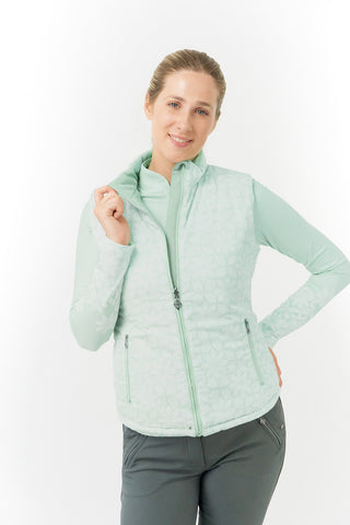 Frosted Sage Pure Golf Eve reversible ladies gilet for golf is insulated, winter-weight, patterned and reversible. It has been Insulated for warmth without being bulky. It has a unique frosted field, floral print  on one side and plain frosted sage on the other for versatility of wear. It has pockets on both sides and two-way zippers. The flattering quilting style and fit enhances your silhouette. 