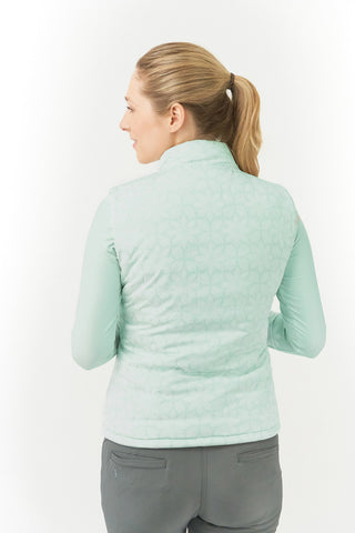 Frosted Sage Pure Golf Eve reversible ladies gilet for golf is insulated, winter-weight, patterned and reversible. It has been Insulated for warmth without being bulky. It has a unique frosted field, floral print  on one side and plain frosted sage on the other for versatility of wear. It has pockets on both sides and two-way zippers. The flattering quilting style and fit enhances your silhouette. 