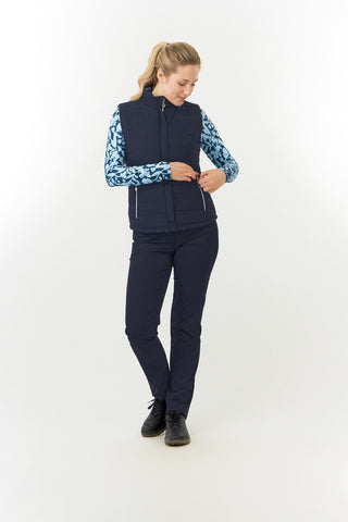 Pure Golf Eve reversible ladies gilet for golf is insulated, winter-weight, patterned and reversible. It has been Insulated for warmth without being bulky. One side features intricate Midnight Rose floral prints in navy and powder blue, while the other offers a classic plain navy option for versatility of wear. It has pockets on both sides and two-way zippers. The flattering quilting style and fit enhances your silhouette. 