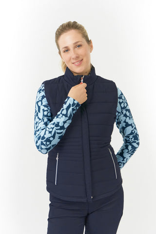 Pure Golf Eve reversible ladies gilet for golf is insulated, winter-weight, patterned and reversible. It has been Insulated for warmth without being bulky. One side features intricate Midnight Rose floral prints in navy and powder blue, while the other offers a classic plain navy option for versatility of wear. It has pockets on both sides and two-way zippers. The flattering quilting style and fit enhances your silhouette. 