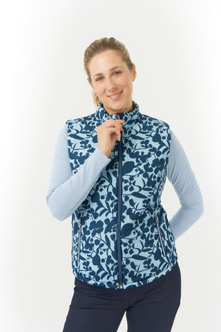 Pure Golf Eve reversible ladies gilet for golf is insulated, winter-weight, patterned and reversible. It has been Insulated for warmth without being bulky. One side features intricate Midnight Rose floral prints in navy and powder blue, while the other offers a classic plain navy option for versatility of wear. It has pockets on both sides and two-way zippers. The flattering quilting style and fit enhances your silhouette. 