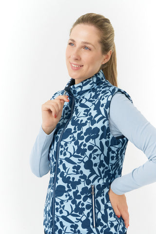 Pure Golf Eve reversible ladies gilet for golf is insulated, winter-weight, patterned and reversible. It has been Insulated for warmth without being bulky. One side features intricate Midnight Rose floral prints in navy and powder blue, while the other offers a classic plain navy option for versatility of wear. It has pockets on both sides and two-way zippers. The flattering quilting style and fit enhances your silhouette. 