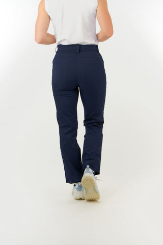 Navy Ladies golf trousers made from flexible lightweight 4 way stretch material.  Featuring a zip and button fastening with five belt loops, a regular fit with anti-crease and anti-static properties. These women's golf trousers have two open pockets to the front and back. Size 8 to 20.