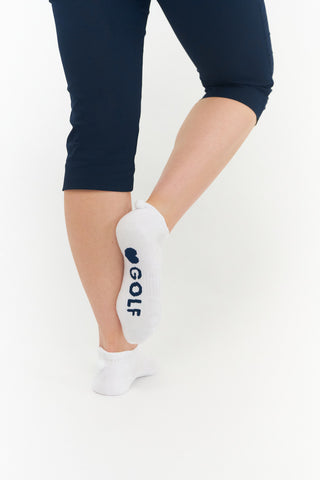 3 pair pack of ankle ladies golf socks, one pair in white with Navy detail on the sole and two pairs in white with Navy heals, toe, cuff and the word golf along the sole. With coordinating colour pom pom on the heel to help the socks hold their position. Made from a soft, stretchy cotton blend fabric allowing breathability, with a cushioned sole and compression fit. They are suited to UK sizes between 4 and 7. 85% Cotton, 13% Polyester, 2% Elastane.