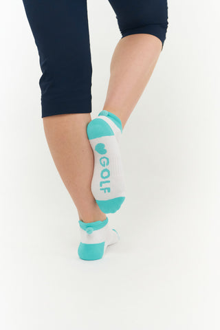 3 pair pack of ankle ladies golf socks In white with coloured heals, toe and cuff in Pink, Blue & Aqua, and matching word golf along the sole. With coordinating colour pom pom on the heel to help the socks hold their position. Made from a soft, stretchy cotton blend fabric allowing breathability, with a cushioned sole and compression fit. They are suited to UK sizes between 4 and 7. 85% Cotton, 13% Polyester, 2% Elastane.