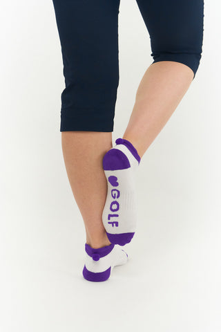 3 pair pack of ankle ladies golf socks In white with coloured heals, toe and cuff in Pink, Blue & Aqua, and matching word golf along the sole. With coordinating colour pom pom on the heel to help the socks hold their position. Made from a soft, stretchy cotton blend fabric allowing breathability, with a cushioned sole and compression fit. They are suited to UK sizes between 4 and 7. 85% Cotton, 13% Polyester, 2% Elastane.