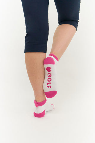 3 pair pack of ankle ladies golf socks, one pair in white with pink detail and two pairs in white with Pink heals, toe, cuff and thone e word golf along the sole. With coordinating colour pom pom on the heel to help the socks hold their position. Made from a soft, stretchy cotton blend fabric allowing breathability, with a cushioned sole and compression fit. They are suited to UK sizes between 4 and 7. 85% Cotton, 13% Polyester, 2% Elastane.