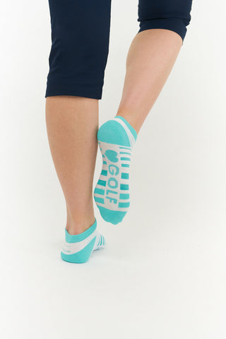 White ladies trainer golf sock, 3 pack with 2 stripped in Aqua and one plain. Cushioned sole and compression fit. The lower cut around the ankle makes them less visible when worn. An attractive stripe design with the word golf on the sole. Made from a soft, stretchy cotton blend fabric allows breathability. They are suited to UK sizes between 4 and 7. 85% Cotton, 13% Polyester, 2% Elastane.