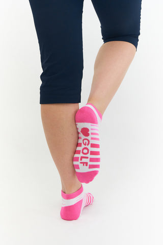 Pink Ladies Golf Trainer Socks come in a 3 pair pack.  The cushioned sole and compression fit provide comfort, while the lower ankle cut makes them less visible when worn. These socks feature an attractive stripe on 2 pairs and 1 white plain design all with the word "golf" on the sole. They are made with a soft, stretchy cotton blend fabric for breathability and are suitable for UK sizes 4-7. Made from 85% cotton, 13% polyester, and 2% elastane.