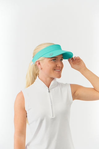 Ocean Blue feminine ladies golf visor constructed with quick-drying fabrics. The visor comes in a one size fits all design with an elasticated cord at the rear to hold it securely in place. It also features a concealed magnet  in peak with a hand enamelled lace golf ball marker attached, making it a lovely golf accessory, golf gift! The headband features a soft lined absorbent towel. 