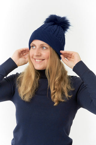 Navy ladies golf hat In an attractive cable knit design. This hat has three layers - an inner waterproof layer plus a soft fleece lining which makes it warm and comfortable. Detachable natural look faux fur bobble.