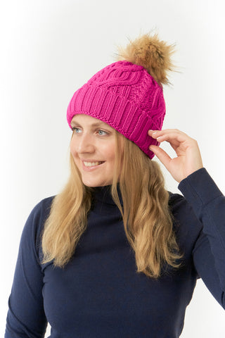 Pink ladies golf hat In an attractive cable knit design. This hat has three layers - an inner waterproof layer plus a soft fleece lining which makes it warm and comfortable. Detachable faux fur bobble in natural colours.