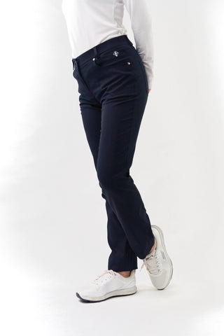 Navy Ladies golf trousers made from flexible lightweight 4 way stretch material.  Featuring a zip and button fastening with five belt loops, a regular fit with anti-crease and anti-static properties. These women's golf trousers have two open pockets to the front and back. Size 8 to 20.