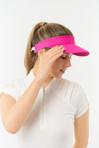 Hot Pink ladies golf visor constructed with quick-drying fabrics. The visor comes in a one size fits all design with an elasticated cord at the rear to hold it securely in place. It also features a concealed magnet  in peak with a hand enamelled lace golf ball marker attached, making it a lovely golf accessory, golf gift! The headband features a soft lined absorbent towel. 